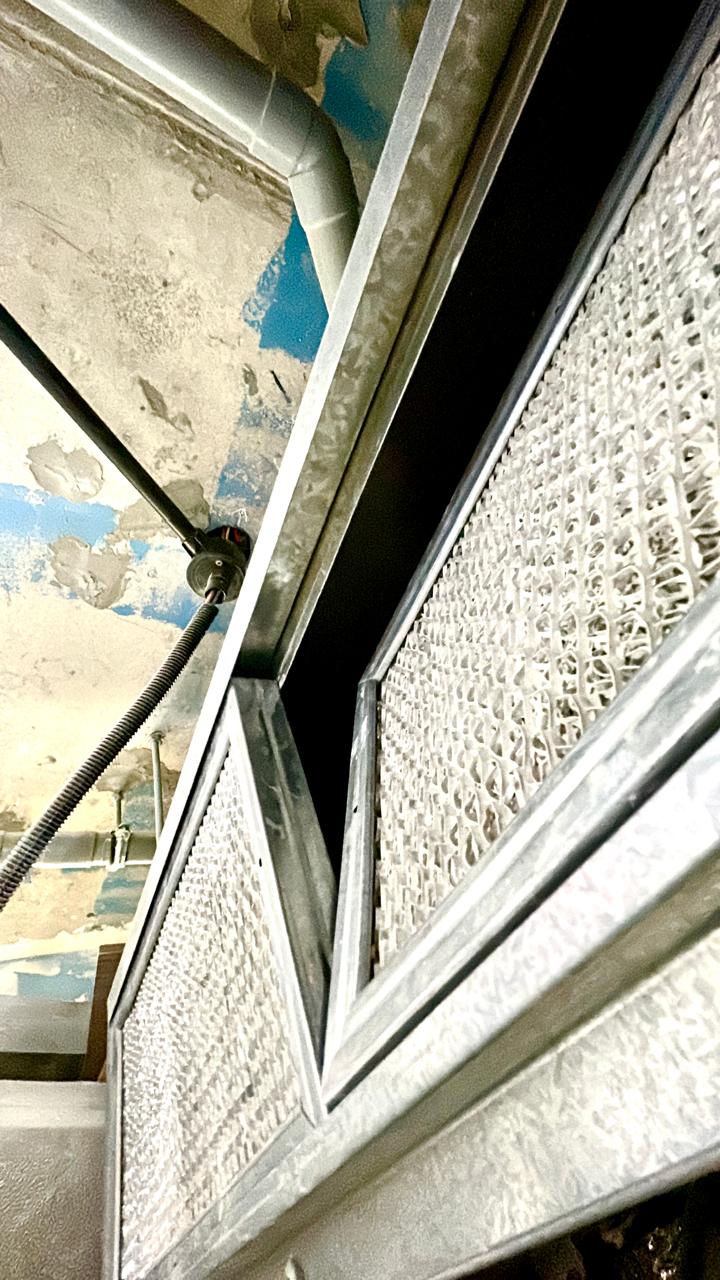 Technician inspecting HVAC and MEP systems in a Dubai building